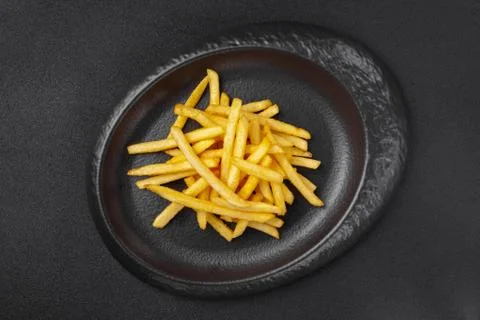 Portion of side dish in gray plate - crispy fat french fries Stock Photos