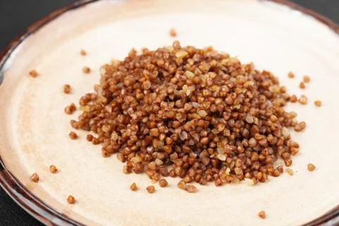 Portion of side dish in gray plate - boiled buckwheat porridge Stock Photos