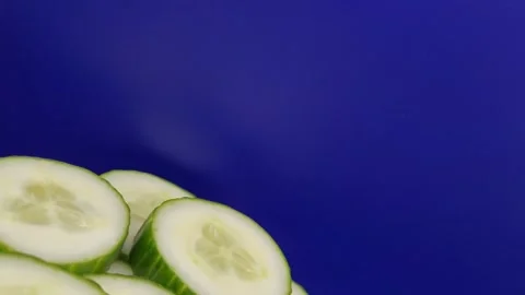 Portion of sliced cucumber on a blue background. Stock Footage 288224488