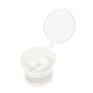 Portion sour cream in a plastic container isolated on a white background. Foto stock