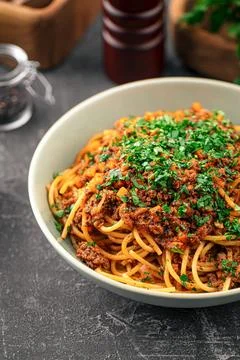 Portion of spaghetti bolognese with herbs Stock Photos