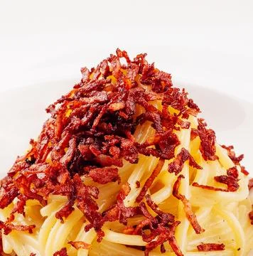 Portion of spaghetti with fried bacon Stock Photos