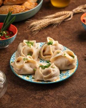Portion of steamed tatar manti dumplings Stock Photos