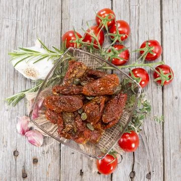 Portion of sun dried Tomatoes with fresh herbs Фото