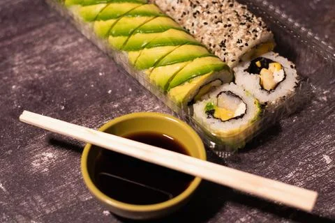 A portion of sushi with avocado wrapper Foto stock