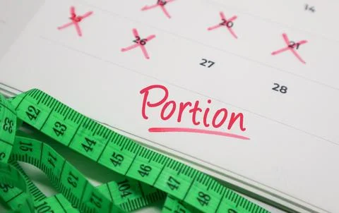Portion text on calendar with measuring tape. Concept of diet control, food.. Stock Photos