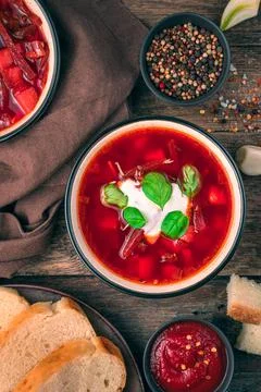 A portion of vegetable soup with tomato and beetroot, sour cream and basil. F Stock Photos