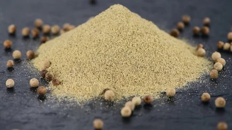 Portion of White Pepper rotating on a wooden plate (not loopale; 4K) Stock Footage