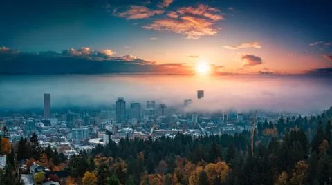Portland downtown with rolling fog and autumn foliage in shining sunrise and Stock Photos