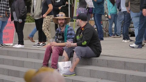 Portland Saturday Market - Two Interesting Guys Sitting on Steps and Talking Stock Footage