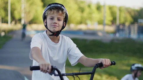 Portrait of 10 Year Old Boy in Helmet Riding BMX Bicycle Outdoors Video stock 346165973
