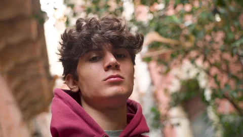 Portrait of a 19 years boy looking downward Stock Footage 257239295