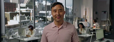 Portrait of 30s male worker is posing to the camera, busy office Stock Footage 254691577
