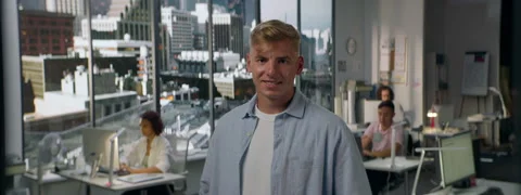 Portrait of 30s male worker is posing to the camera, busy office Stock Footage 254692061