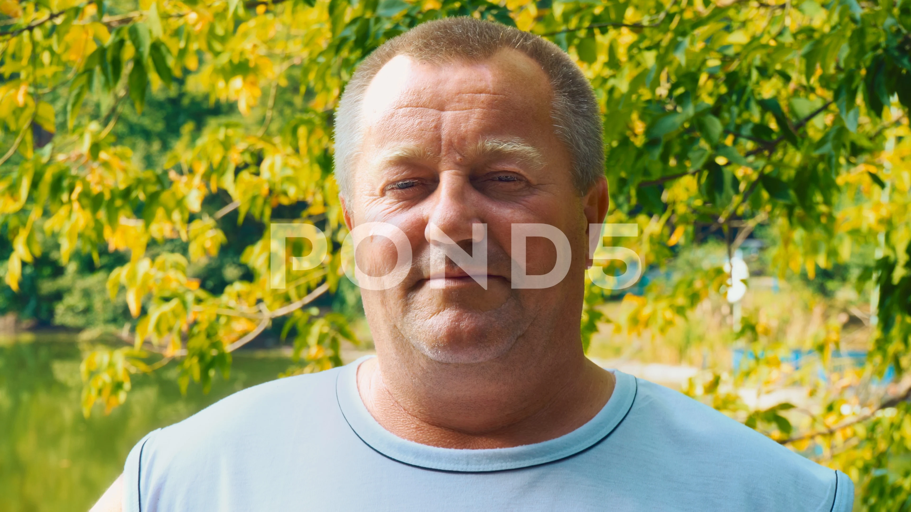 Portrait of a 50-year-old chubby man against the backdrop of natures greenery pic