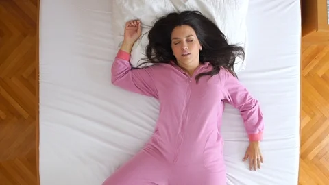 Portrait from above of cute plus size model sleeping during the morning light. Stock Footage 119721951