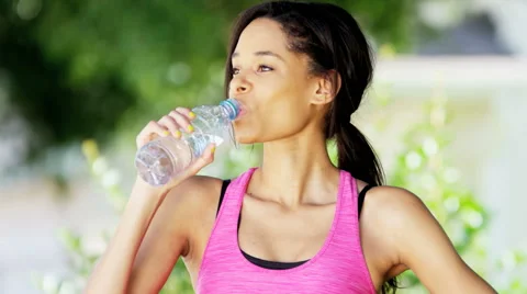 Teen girl drinking water from bottle in summer park. Drinking water in the  heat concept. Close-up Stock Video Footage by ©lizaelesina #489034632