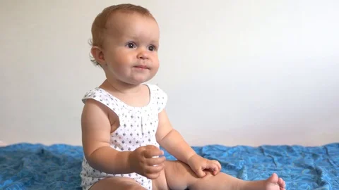 Portrait of active baby playing on the bed at home. 스톡 동영상 123766446