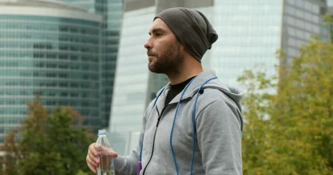 Portrait of active man drinking from water bottle while resting from training Stock Footage 162690354