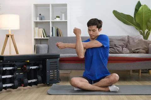 Portrait of active millennial man doing morning workout at home. Sporty lif.. Foto stock