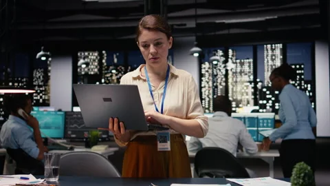 Portrait of administrator using laptop in office to evaluate business efficiency Stock Footage 334039930