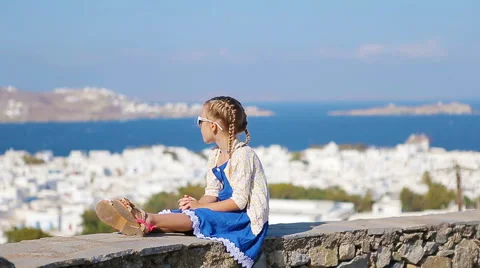 Portrait of adorable little girl background Mykonos town in Europe Stock Footage