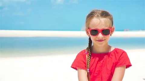 Portrait of adorable little girl at beach during summer vacation. SLOW MOTION Stock Footage