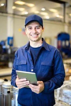 Portrait af an engineer using a tablet in a facility Photos