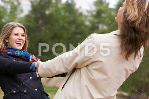 Portrait of affectionate couple whirling outside Stock Photos