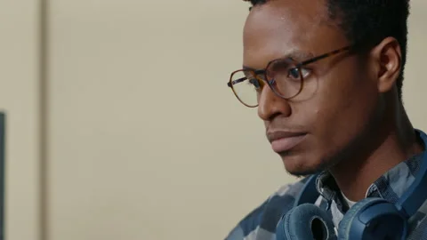 Portrait of african american database developer with glasses working focused Stock Footage 168232018