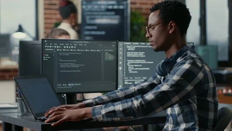 Portrait of african american developer using laptop to write code sitting at Stock-Footage 168245309