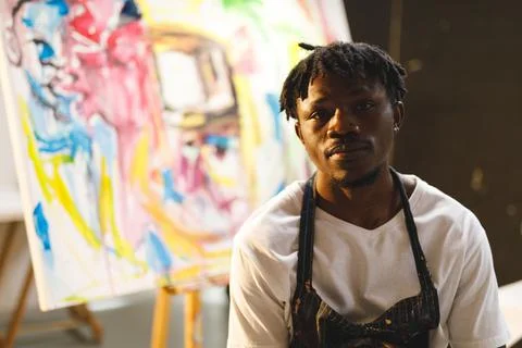 Portrait of african american male painter at work looking at camera in art Stock Photos