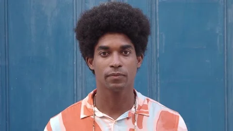 Portrait of an African American man with afro hair looking seriously at camera. Stock Footage 165212341