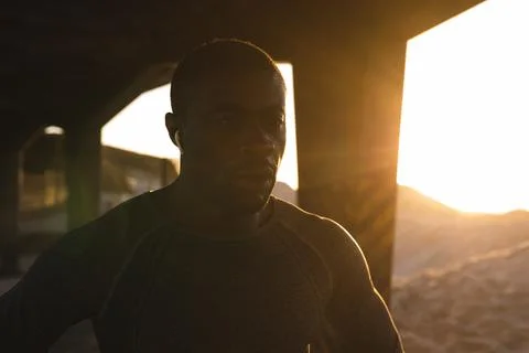 Portrait of african american man exercising outdoors under bridge at sunset Stock Photos