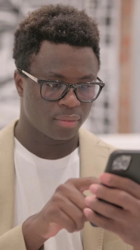 Portrait of African American Man using Smartphone, vertical video Stock-Footage 328566689
