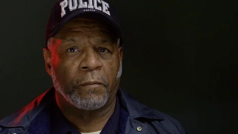 Portrait of an African American police officer, close up Stock Footage