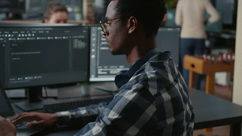 Portrait of african american programer typing on laptop sitting at desk with Stock Footage 168250975
