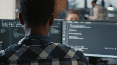 Portrait of african american programer typing on laptop sitting at desk with 写真素材