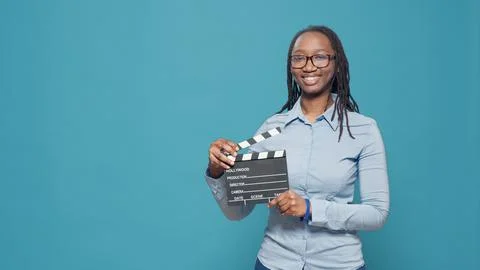 Portrait of african american woman holding film slate board Stock Photos
