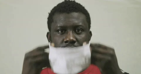 Portrait Of An African American Wrongly Putting On A Protective Mask Against Stock Footage 127741362