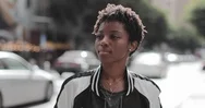 Portrait Of African American Young Adult Female On Busy City Street Stock Footage