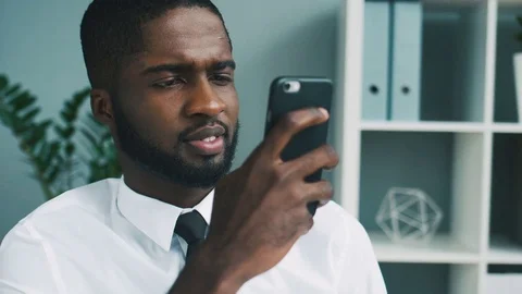 Portrait of african business man using cell phone for working in the office Stock Footage 75734516