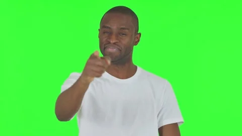 Portrait of African Man Pointing at Camera on Green Background Stock Footage 295161274