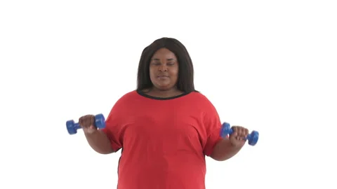 Portrait of african oversize model doing overhead shoulder press with dumbbells Stock Footage 134571916
