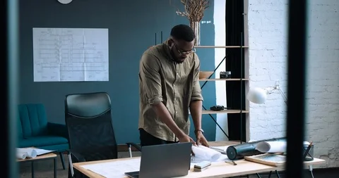 Portrait of Afro-American architect working in Loft office with blueprints Vídeo Stock 126235582