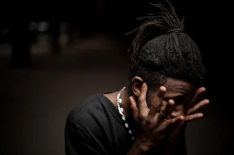 Portrait of the afro american guy with hands near his face 스톡 사진