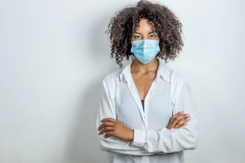 Portrait of an afro woman with surgical mask and crossed hands Stock Photos