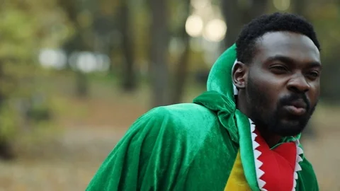 Portrait of afro young man dinosaur funny prankster looking forward searching Stock Footage 115670025