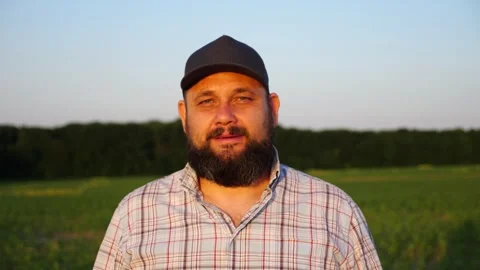 Portrait of agronomist with beard with cornfield at background. Serious farmer Video stock 297362164