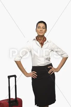 Portrait of an air hostess with her luggage Stock Photos